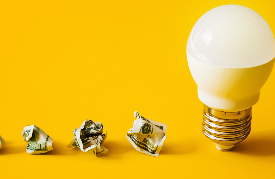 yellow background with dollars and a lighbulb
