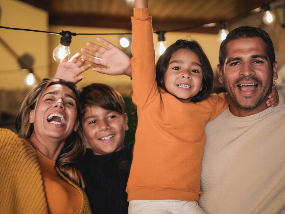 Happy latin family smiling on camera - Love concept