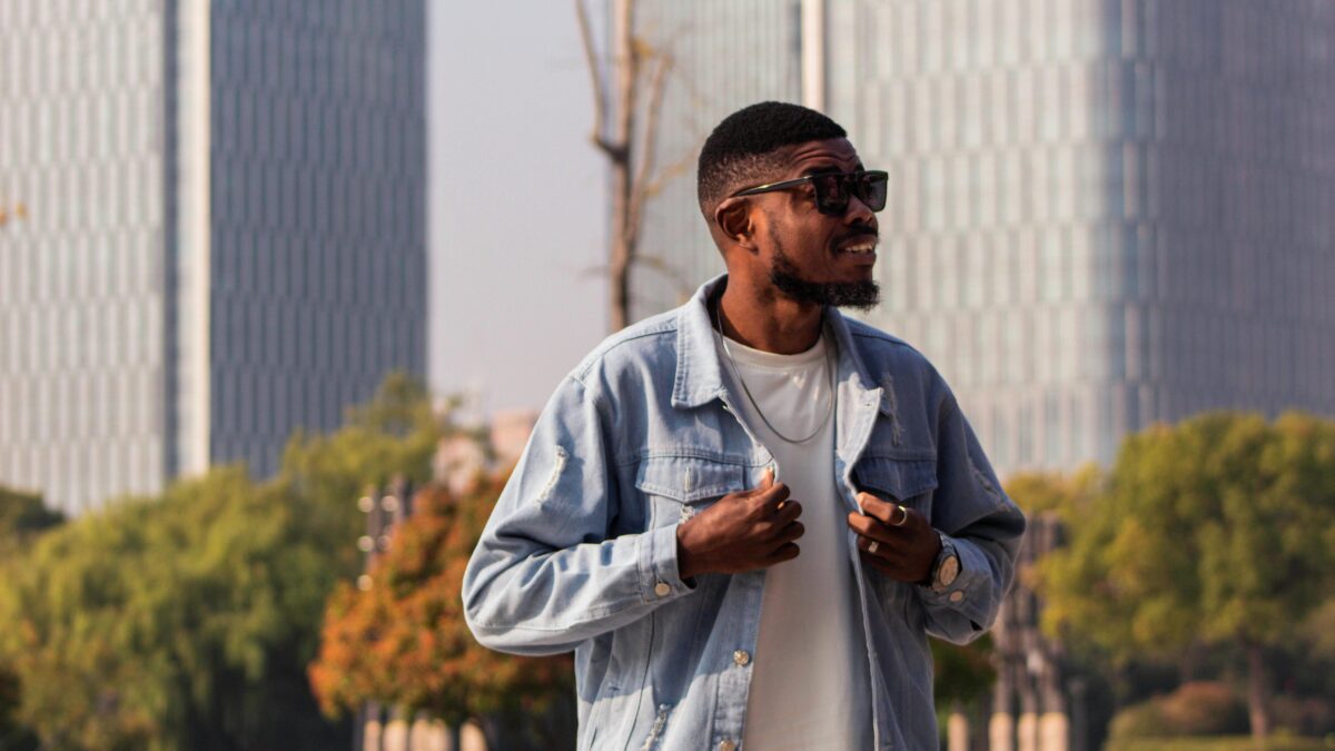 Black man smiling holding his clothes