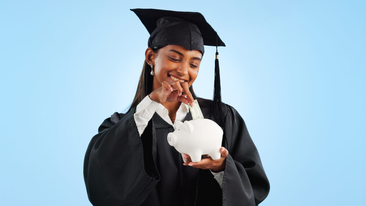 Woman, graduation and piggy bank in studio, saving and cash for investing, future or goals by blue .