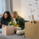 college female teenagers sits on bed and using mobile phone dorm