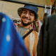 Smiling Man Shopping for Clothing in Thrift Store