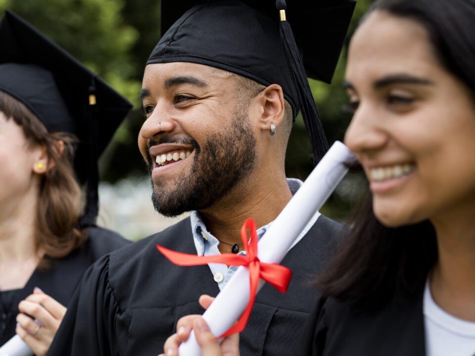 Happy diverse students graduating university, celebrating with d