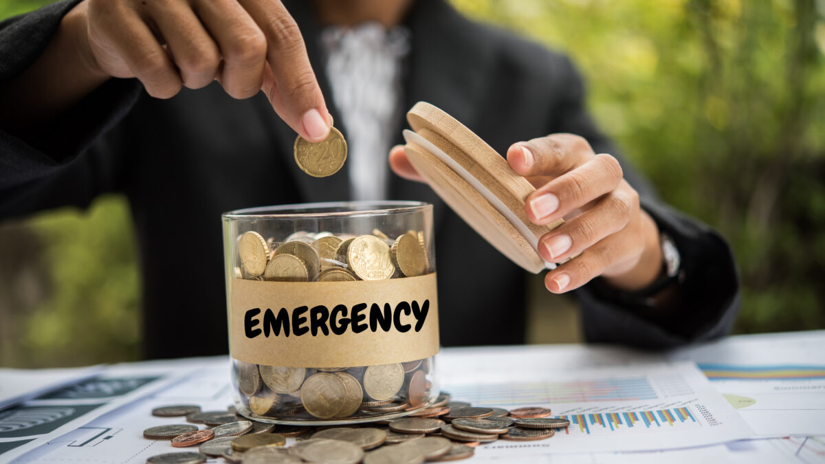 Saving Money putting coins into a jar.